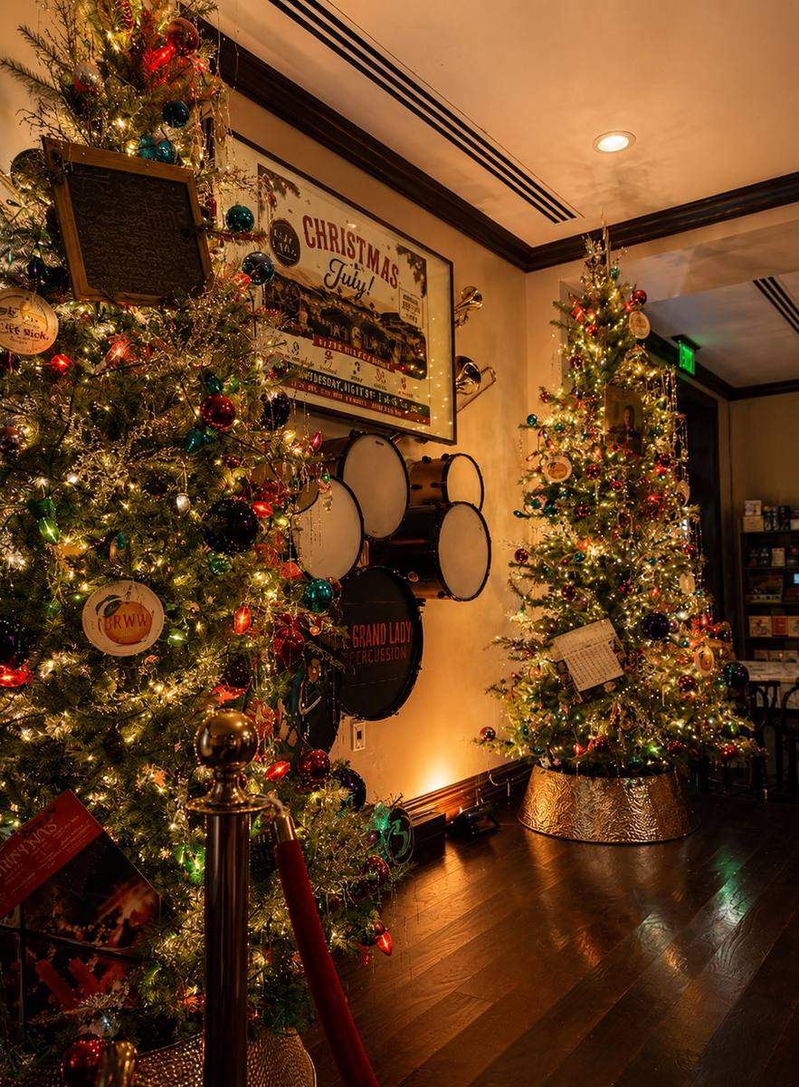 Two Christmas trees flanking a doorway in a decorated venue, styled by Light the Lights